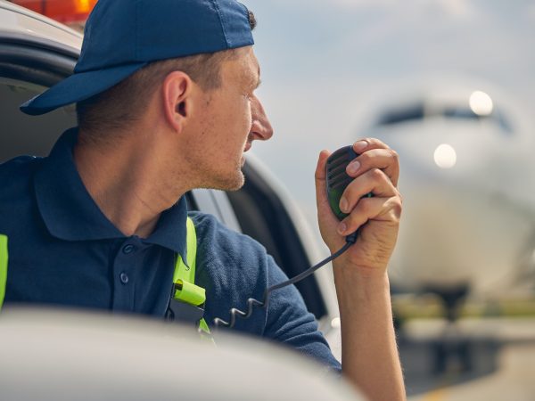 Airport car driver using a two-way radio